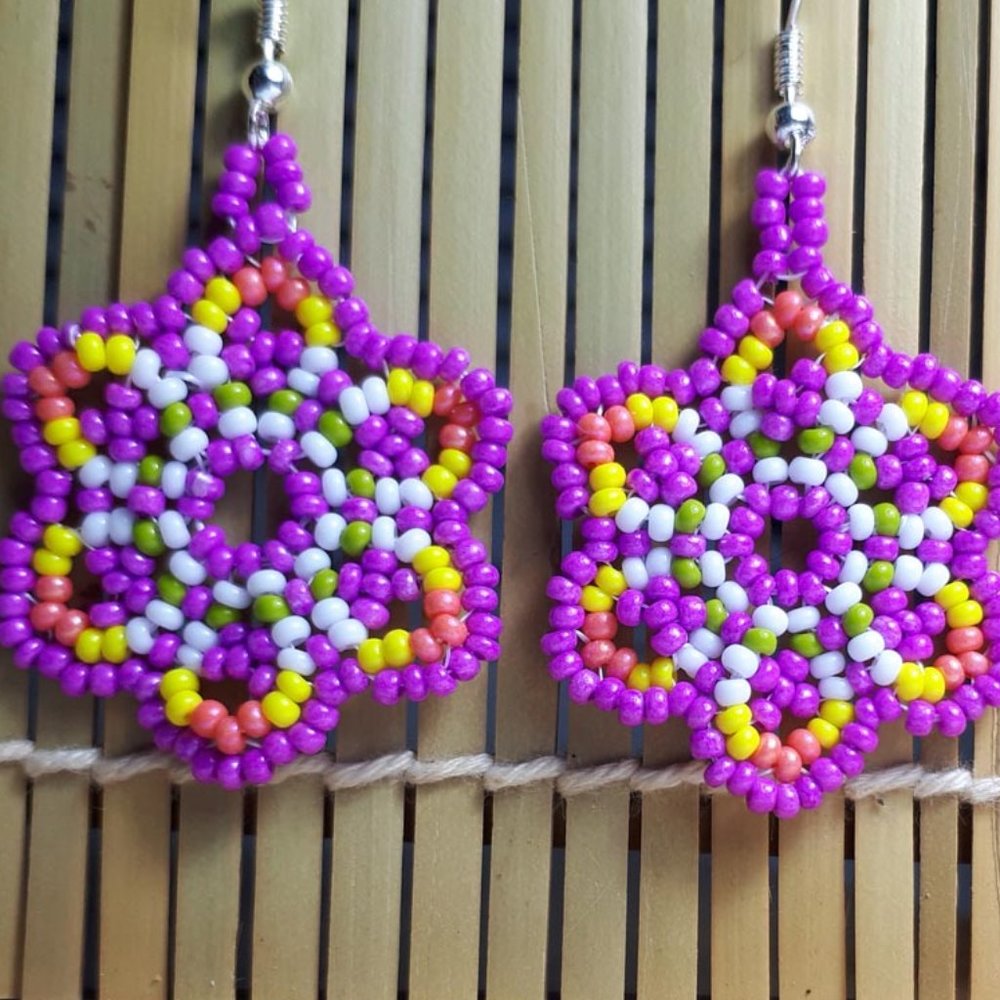 Handcrafted glass bead daisy earrings in purple sunset. 2"